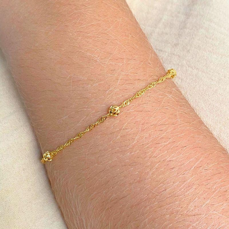 PULSEIRA TRANÇADA COM 5 BOLINHAS TRABALHADAS