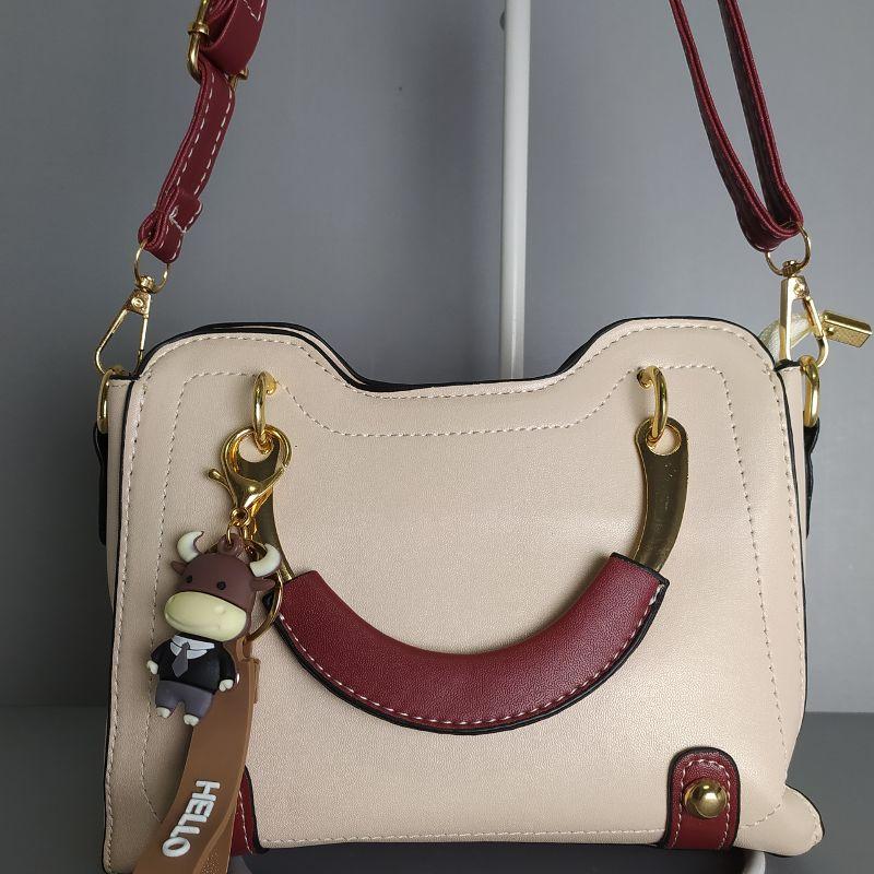 BOLSA PEQUENA ALÇA EM FORMA DE U COM CHAVEIRO DE VAQUINHA